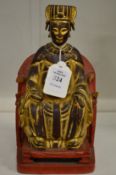A carved, gilded and painted Chinese seated figure.