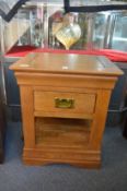 A modern oak single drawer lamp table and another table.