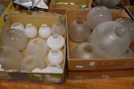 A quantity of glass oil lamp shades.