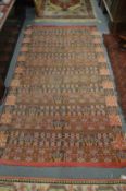 An eastern woven rug with geometric decoration, 230cms x 127cms.