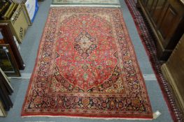 A red ground floral decorated Persian design rug, 210cms x 135cms.
