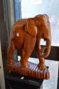 A large carved wood model of an elephant.