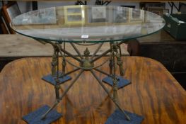 An ornate brass and glass circular coffee table.