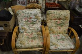 A bamboo conservatory suite and similar table.