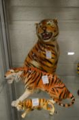 Three porcelain models of tigers.
