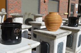 A pair of black glazed garden pots and a ribbed terracotta pot.