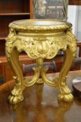 A carved giltwood stand.