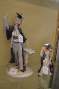 A Capodimonte figure of a school teacher and a schoolchild.