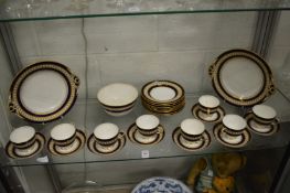 A set of eight teacups and saucers with rich blue banding and gilded decoration together with
