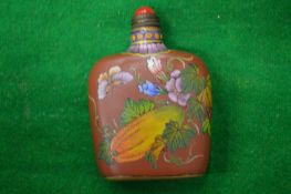 A Chinese lacquer snuff bottle.