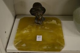 An alabaster ashtray with bronze bust.