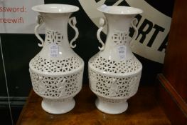A pair of Chinese style Blanc-de-Chine reticulated vases.