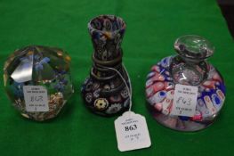 A millefiori style bud vase, a similar inkwell / paperweight and another paperweight.