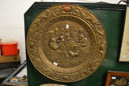 A large embossed brass charger.