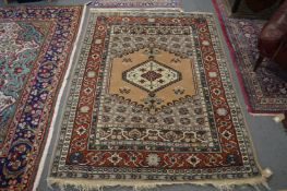 A Persian style rug, beige ground with stylized decoration, 180cms x 135cms.