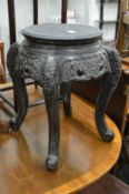 A Chinese carved wood and ebonised circular stand.