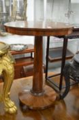 A rosewood pedestal table.