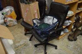 A pair of office swivel armchairs.