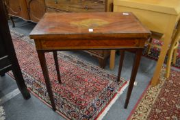 An Edwardian inlaid mahogany foldover card table (faults).