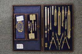 A leather cased drawing instrument set and a similar item.