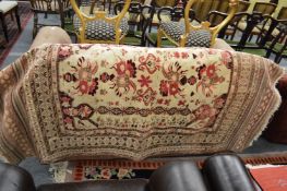 A Persian carpet, cream ground with a floral decoration, 190cms x 125cms.