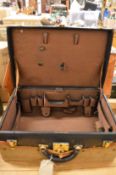 Tiffany & Co, a ladies' leather travelling case with outer canvas cover.