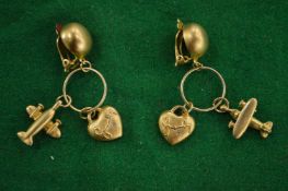 Gilt metal aeroplane ear clips.