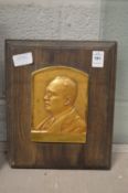 A small relief cast gilt brass portrait plaque.