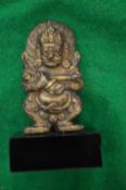 A small Indian bronze god on a marble base.