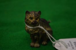 A small cold painted bronze seated cat, possibly Bergman.