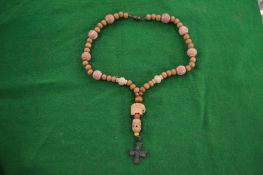 A wooden bead rosary.