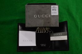 A Gucci key fob, boxed.