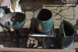 Three garden planters and a small wrought iron table.