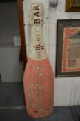 A novelty hotel sign modelled as a large champagne bottle.