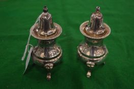 A pair of pedestal salt and peppers.