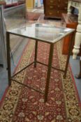 A brass and glass coffee table.