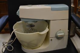 A Kenwood Chef mixer with some attachments.