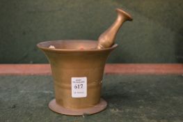 A brass pestle and mortar.