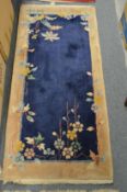 A Chinese rug, blue ground with floral decoration, 150cms x 72cms.