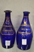 A pair of Bristol Blue and gilt decorated small decanters 