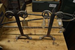 Wrought iron fire dogs and other items.