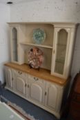 A modern painted and polished oak dresser, the upper section with a pair of glazed doors and
