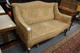 An Edwardian two-seater settee upholstered in an Art Nouveau design fabric.