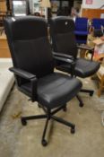 A pair of office swivel armchairs.