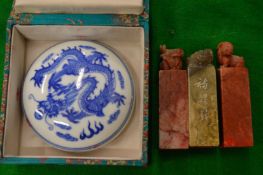 Three Chinese hardstone seals together with a blue and white porcelain inkpot.