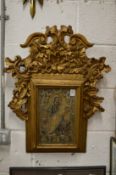 A religious icon in a decorative gilt frame.