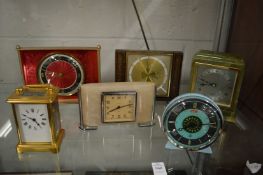 A collection of decorative mantle clocks to include a brass carriage clock.