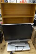 A Monitor DVD player and bookcase.