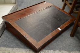A mahogany table top desk.