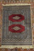 A small Bokhara style rug, 85cms x 63cms.